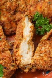 closeup of thinly sliced chicken breast with parsley
