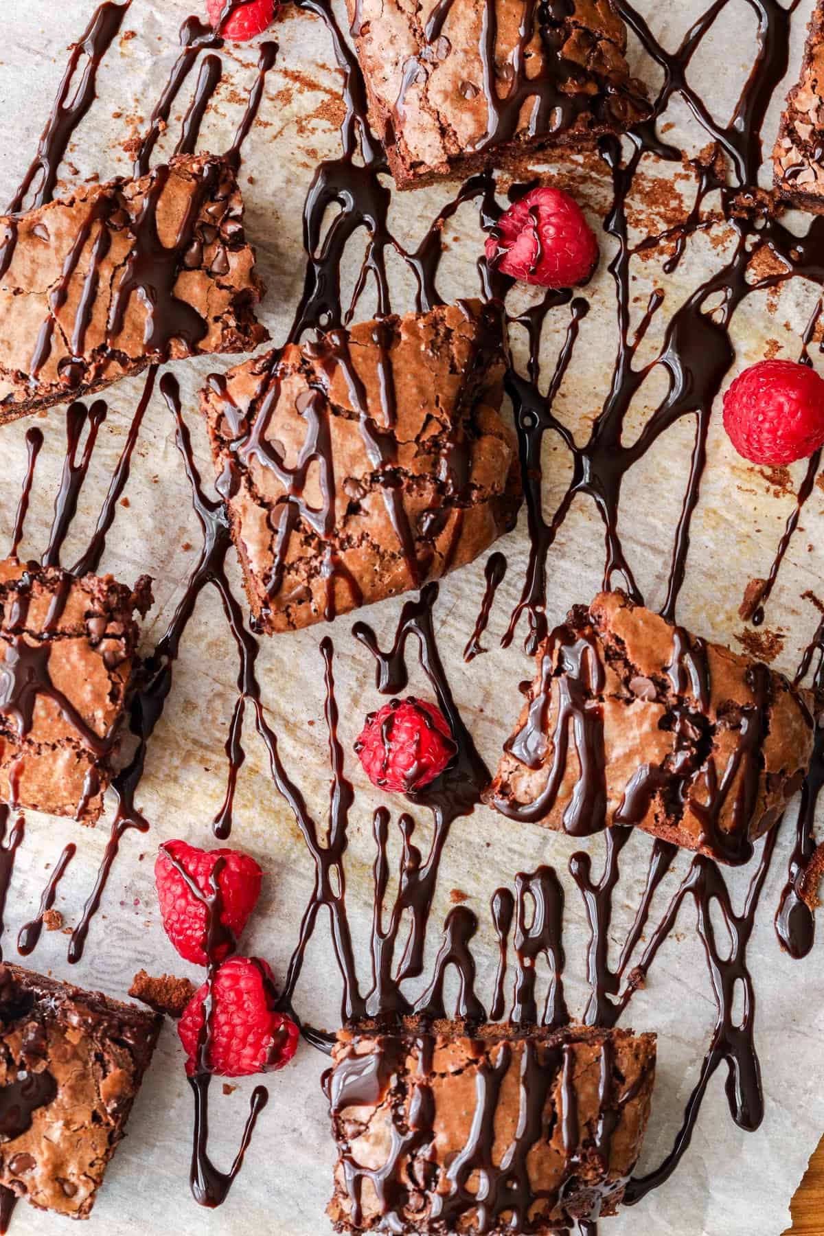 Chocolate fudge brownies and raspberries covered with chocolate syrup
