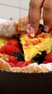 lifting a slice of dutch baby pancakes