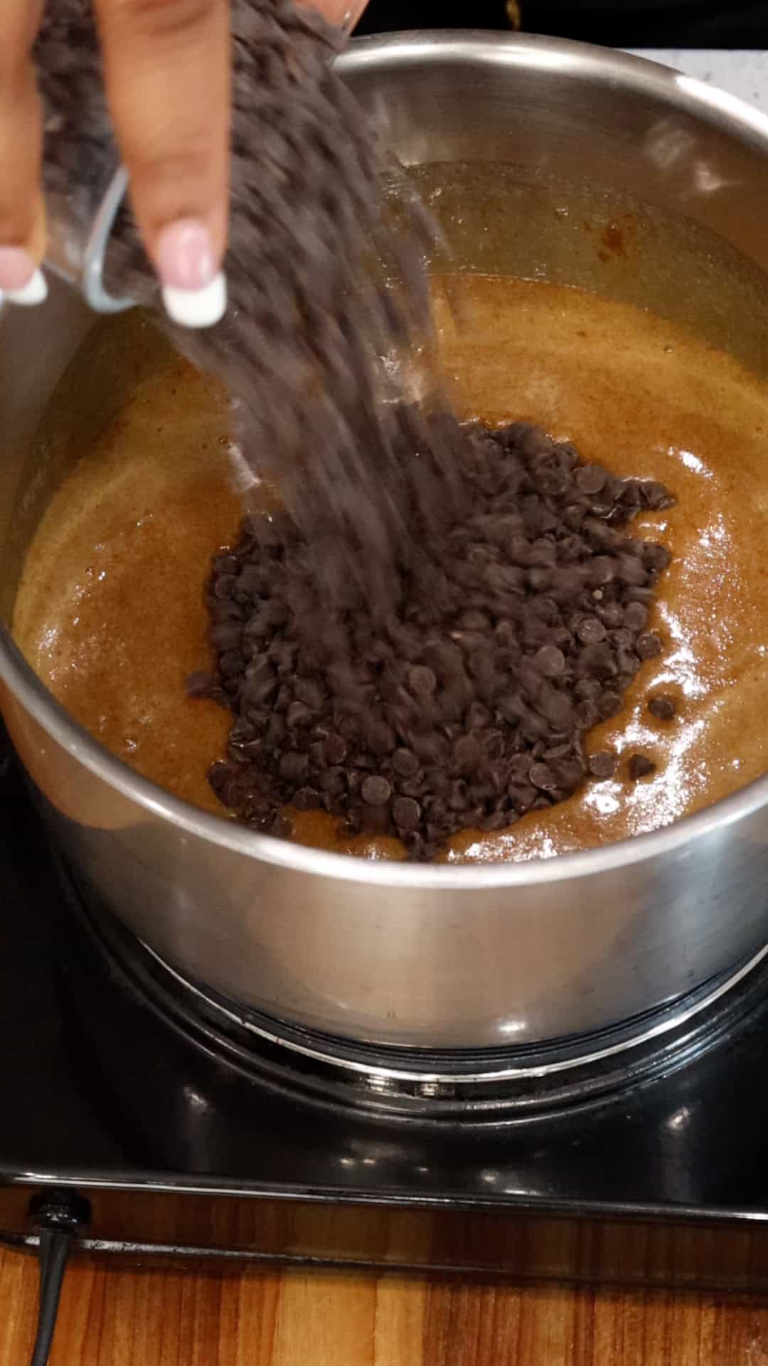 adding chocolate chips to mixture