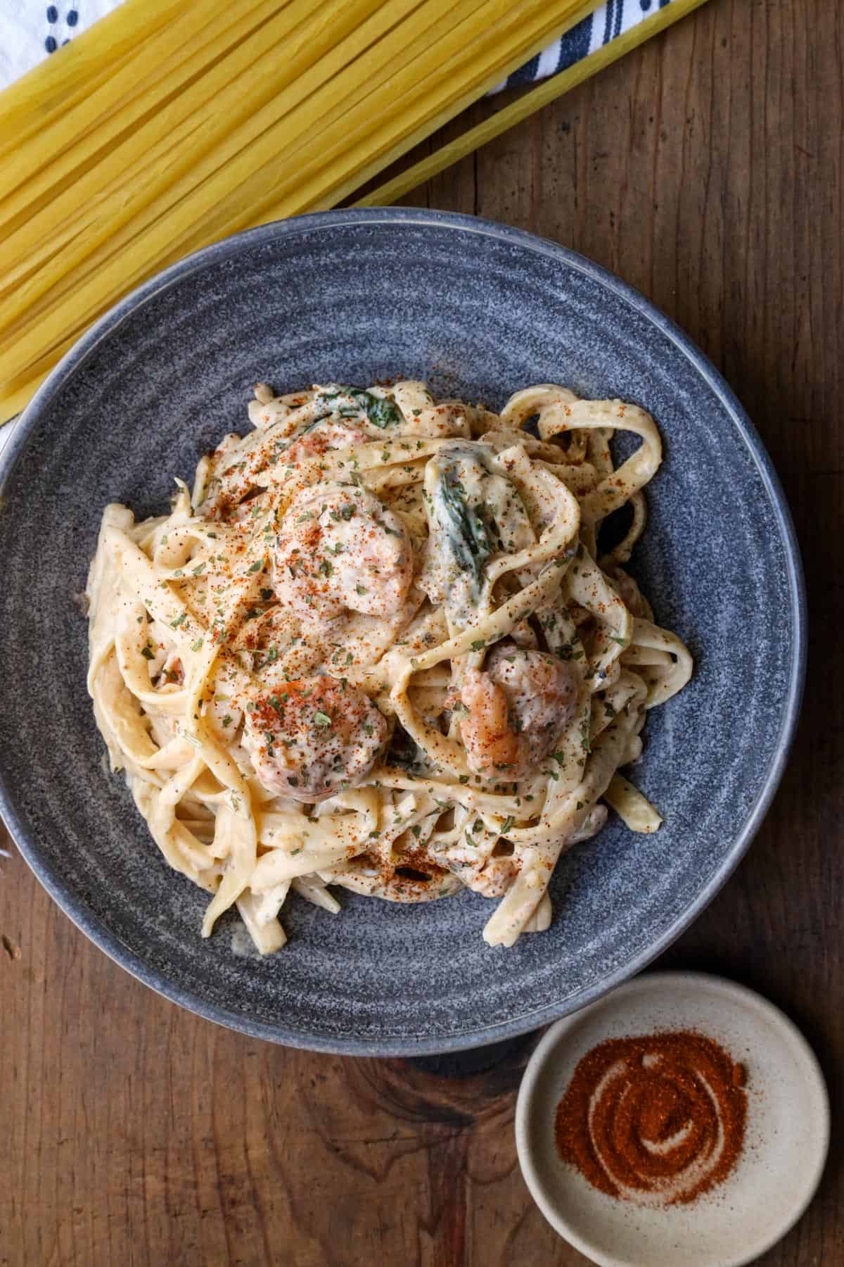 shrimp Alfredo With Spinach in gray bowl