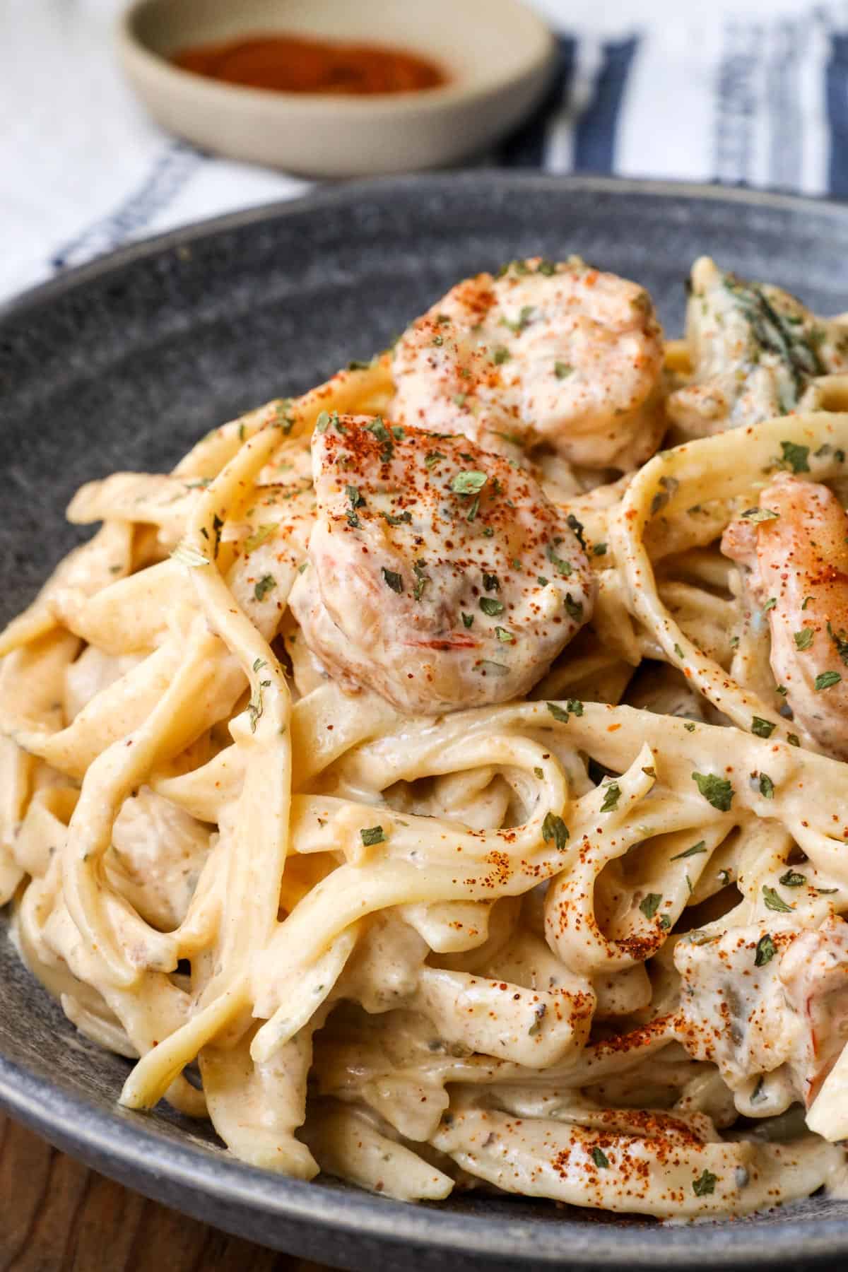 shrimp Alfredo With Spinach in gray bowl