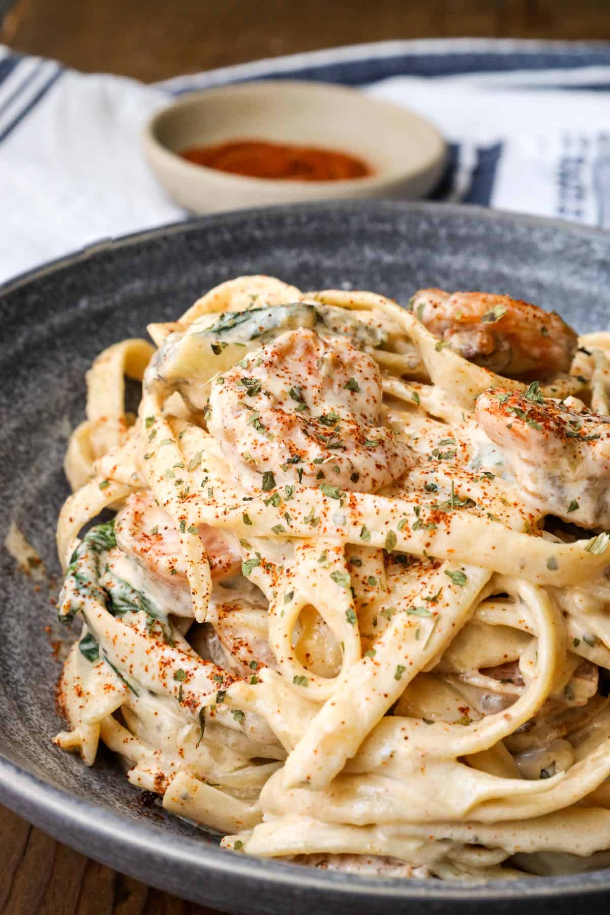 shrimp alfredo with spinach gray bowl