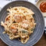 shrimp Alfredo With Spinach in gray bowl