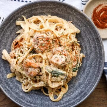 shrimp Alfredo With Spinach in gray bowl