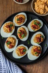 Deviled eggs with crab meat on black plate