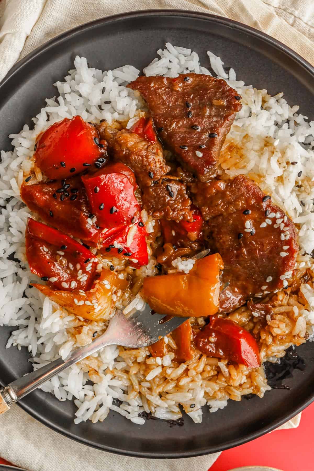 pepper steak and rice on black plate