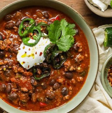 turkey bean chili with cilantro and jalapeño in bowl