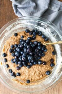 adding blueberries to wet and dry mixture