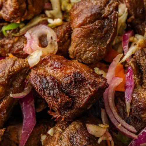 Fried Haitian griot stacked on top of each other