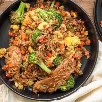 Fried Haitian Black Rice in black plate