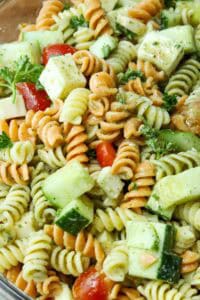 delicious pasta salad with dressing in clear bowl