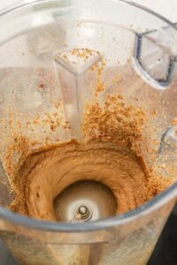 blending peanuts to prepare peanut butter