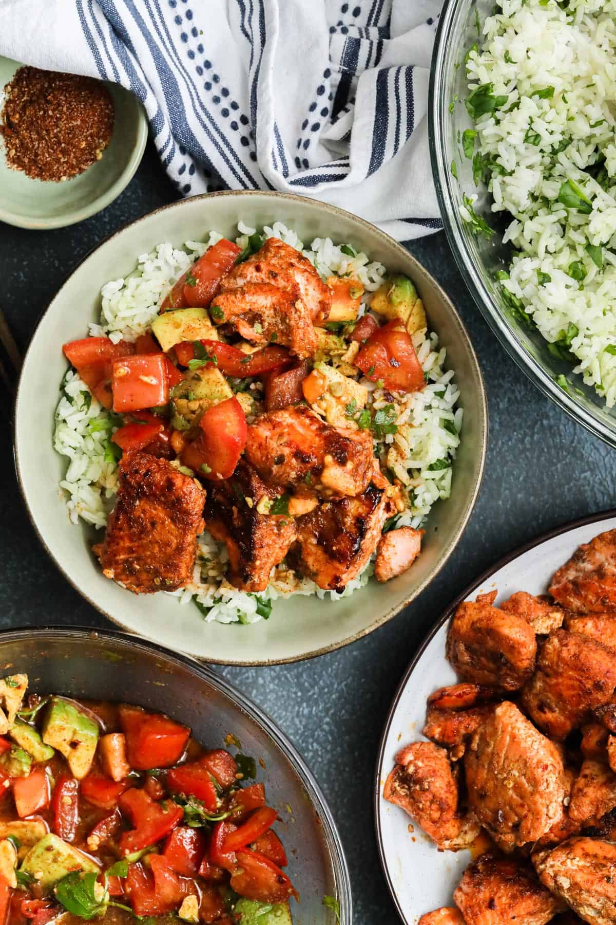 Spicy Chipotle Salmon Bowls on a bed of white rice with spinach