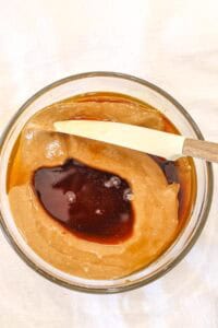 mixing peanut butter, honey, and maple syrup in a bowl