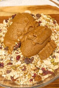 adding peanut butter mixture to granola bars