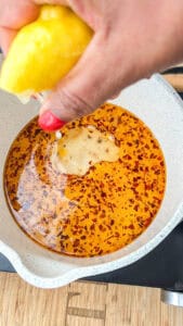 adding lemon juice to oil mixture