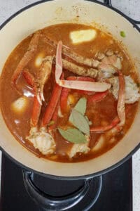 added crab clusters, bay leaves, and liquid to crab bisque