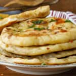 naan bread recipe topped with butter herb and pepper flakes