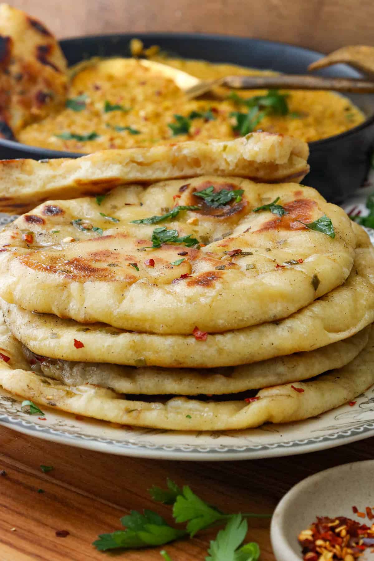 naan bread recipe topped with butter herb and pepper flakes