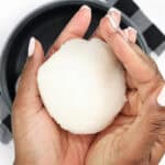 Hand holding Ghanaian Omo Tuo (Rice Balls)