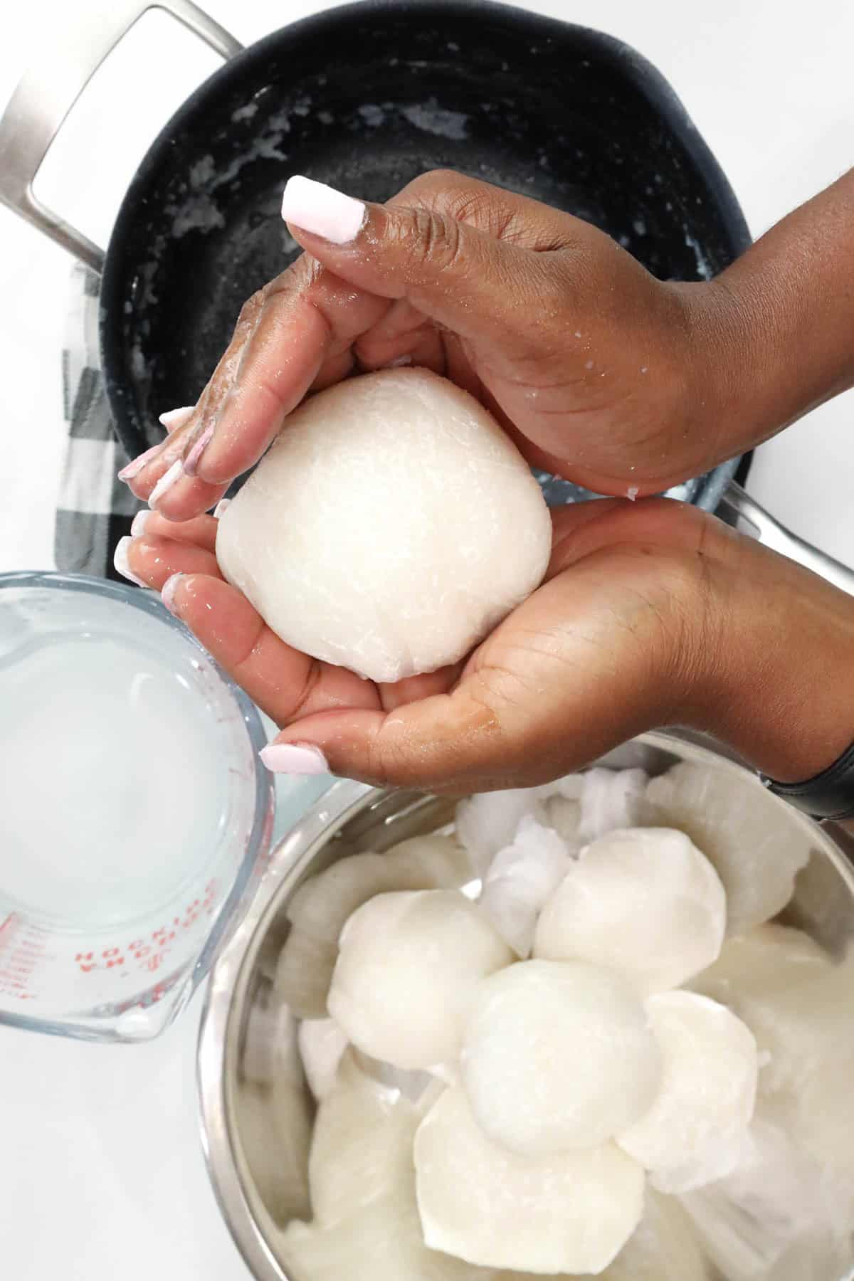 Hand shaping Ghanaian Omo Tuo (Rice Balls)