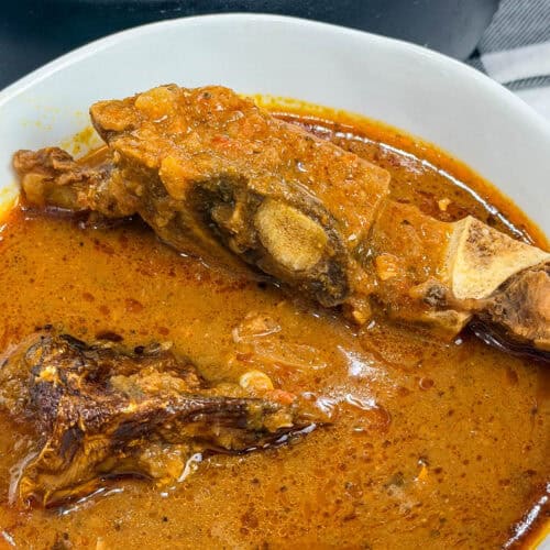 authentic Ghanaian palm nut soup in white bowl