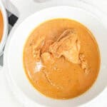 Ghanaian Peanut Butter Soup in white bowl with chicken
