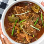 Haitian hard chicken stew in white bowl