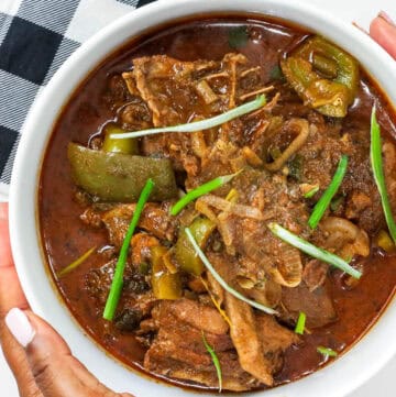 Haitian hard chicken stew in white bowl