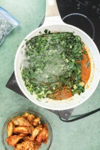 Adding collard greens to make stew