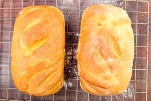 two loafs of bread on cooling rack