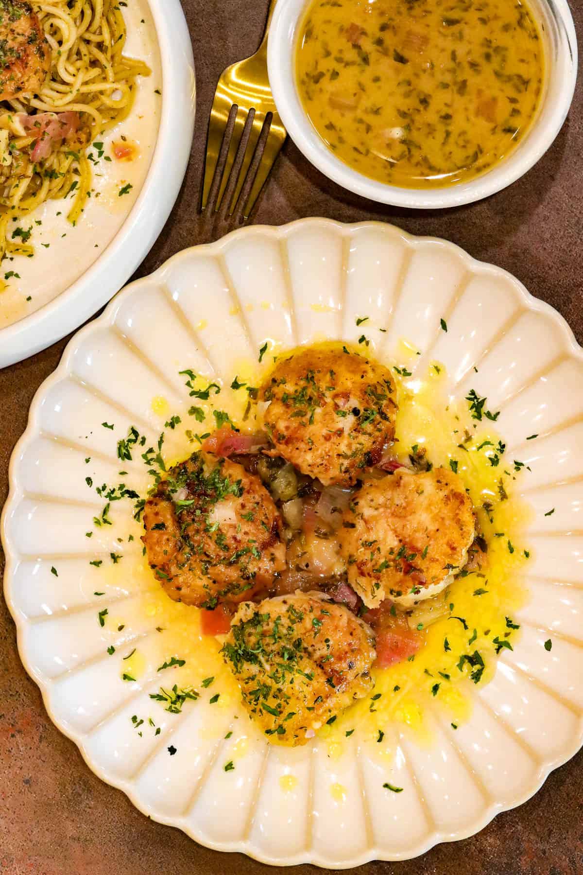 Scallop Provençal on white plate with sauce