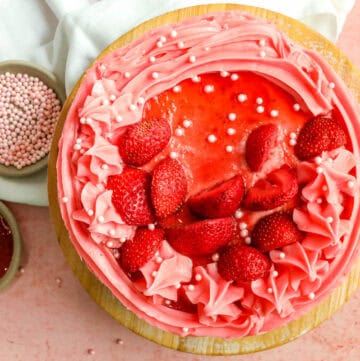 overhead picture of strawberry layer cake with pink sugar pearls