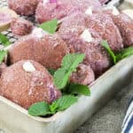 Soft and fluffy Ube donuts filled with vanilla frosting