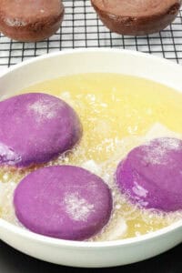 Ube donuts frying in oil