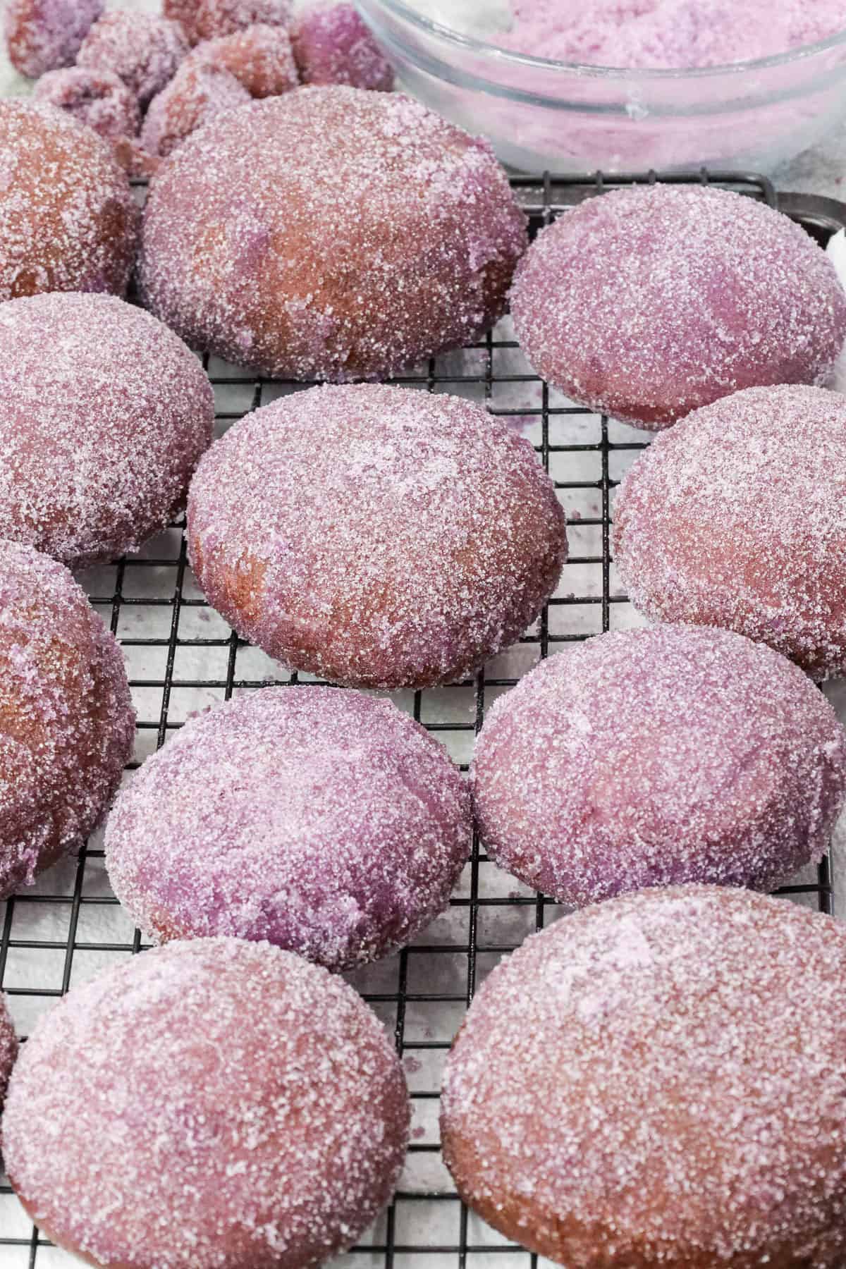 sugar dusted Ube donuts on cooking rack
