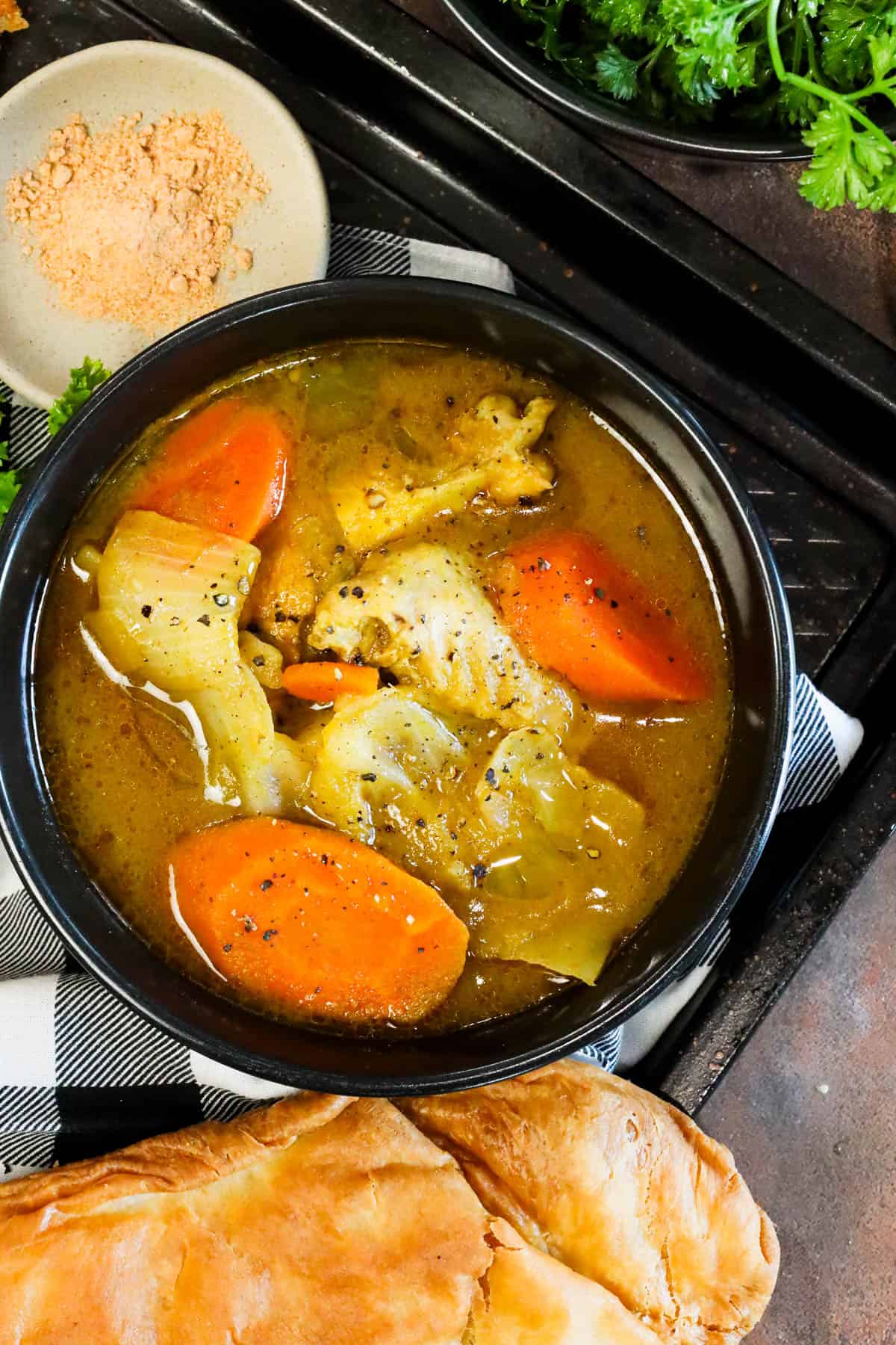 Chicken Soup Joumou with chicken, pumpkin, vegetables, and jumbo pasta shells