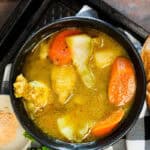 Chicken Soup Joumou (Haitian Chicken Pumpkin Soup) in black bowl