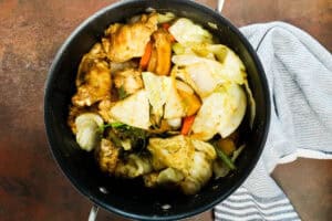 Chicken Soup Joumou (Haitian Chicken Pumpkin Soup) in stockpot with veggies and chicken