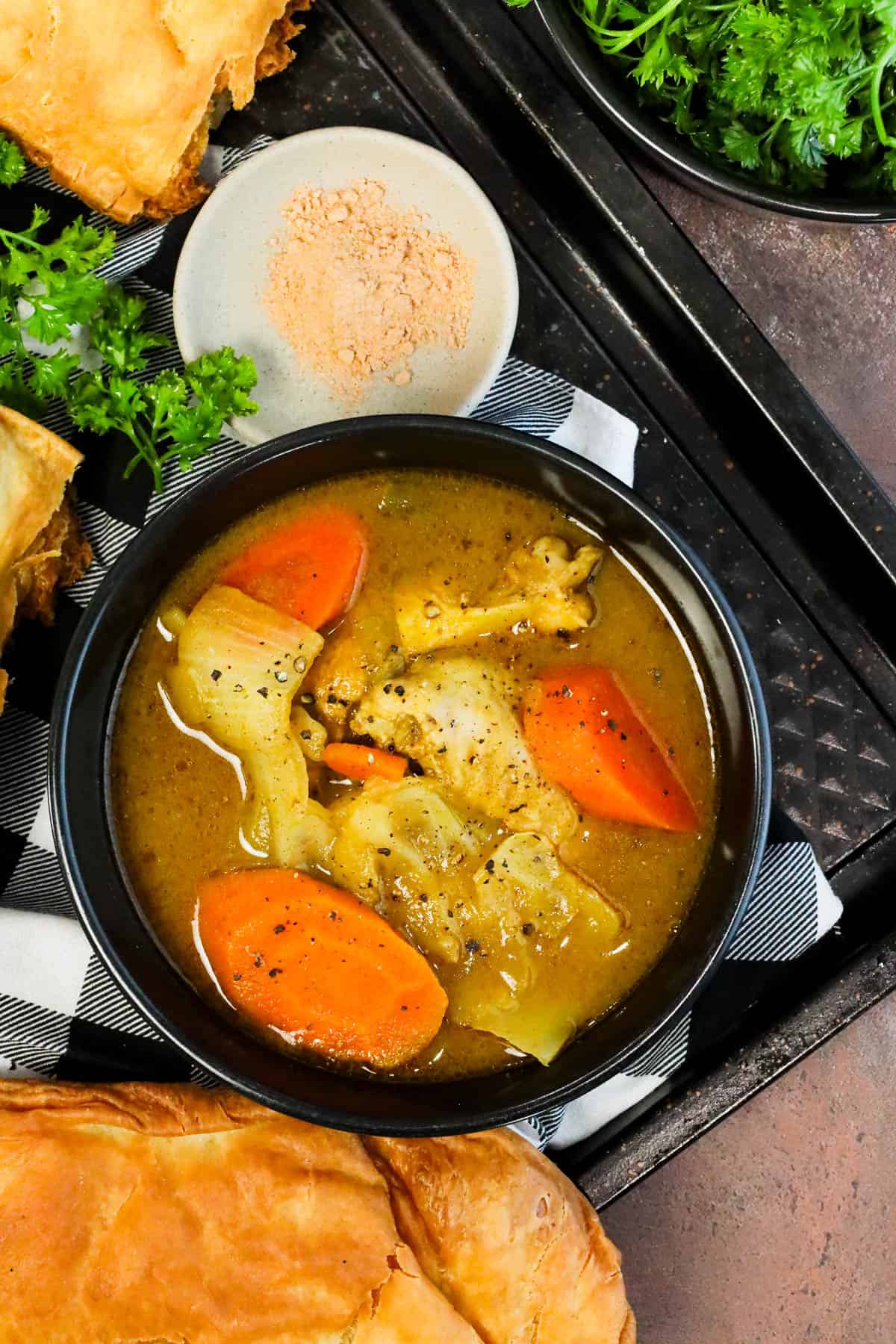 Chicken Soup Joumou with chicken, pumpkin, vegetables, and jumbo pasta shells