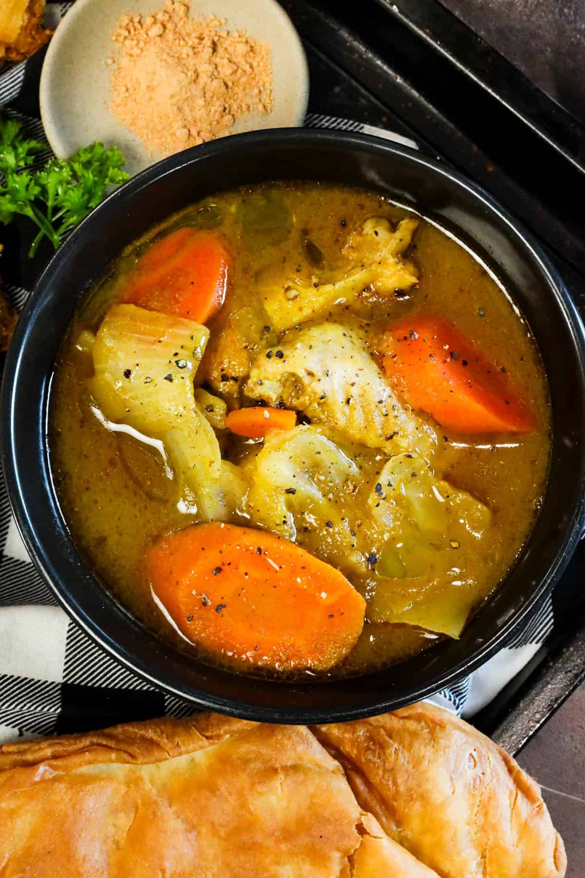 Chicken Soup Joumou with chicken, pumpkin, vegetables, and jumbo pasta shells