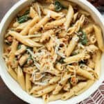 Creamy Marry Me Chicken Pasta with spinach, sun-dried tomatoes, topped with parmesan cheese, and ready to serve