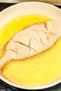frying tilapia in oil in the pan